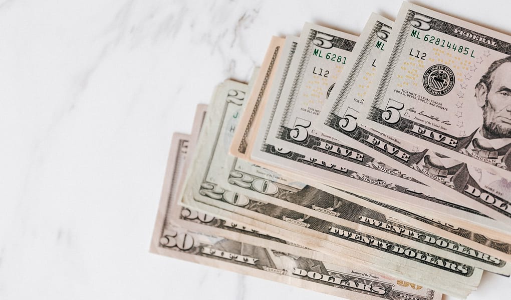 different dollar bills on marble surface