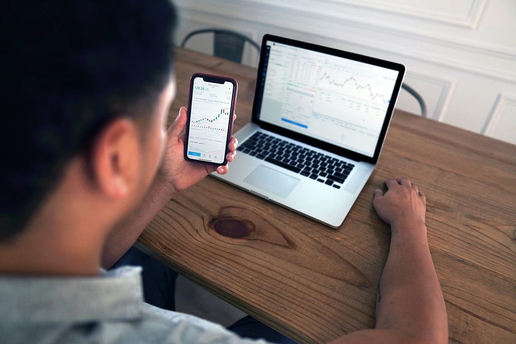 a person using smartphone and laptop