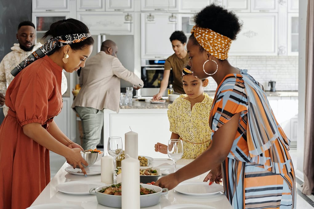family setting the table for dinner