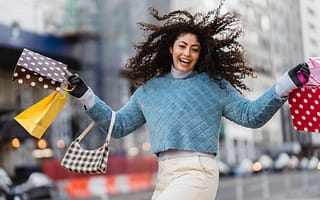 happy woman jumping with shopping bags